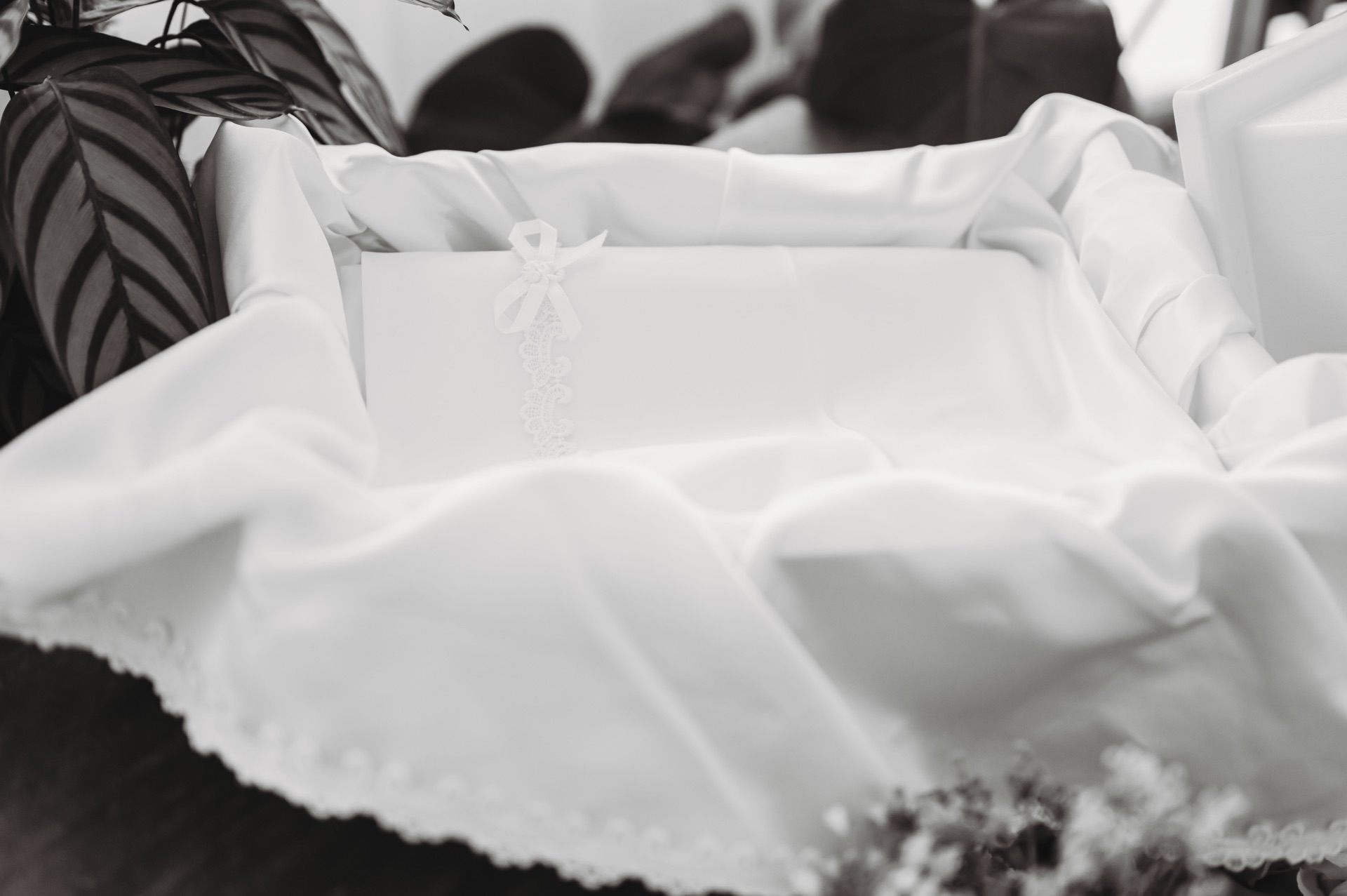 Baby layette in casket with ribbons