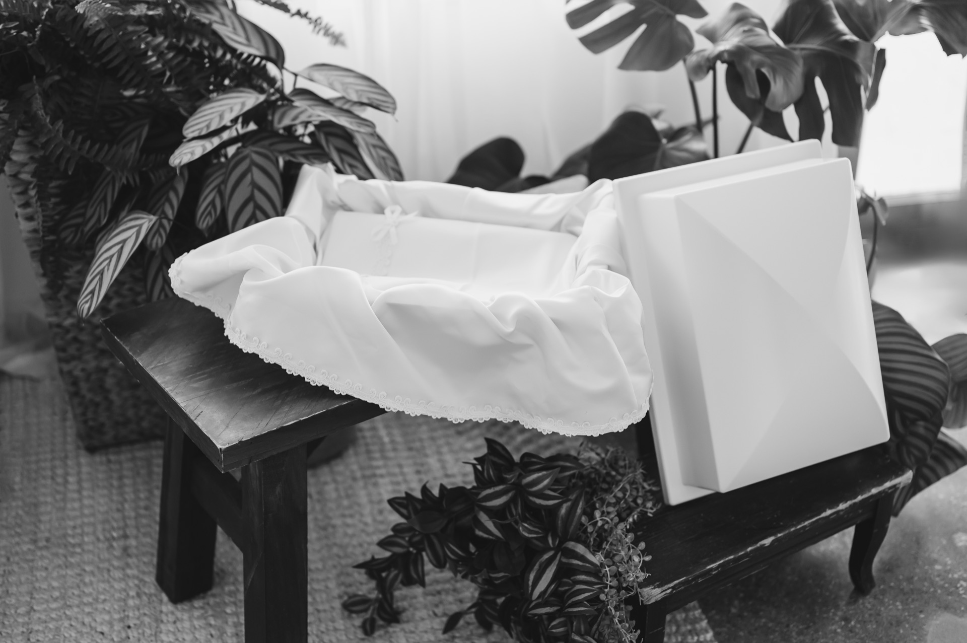 Memorial arrangement with casket, blanket, books, and keepsakes