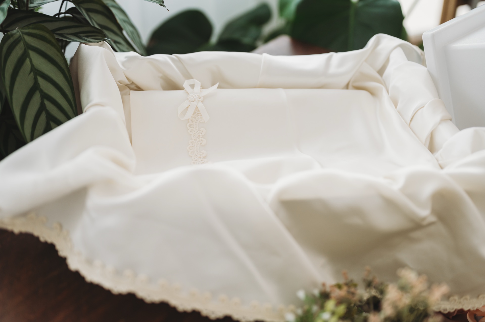 Beautiful baby layette on delicate lace-trimmed casket