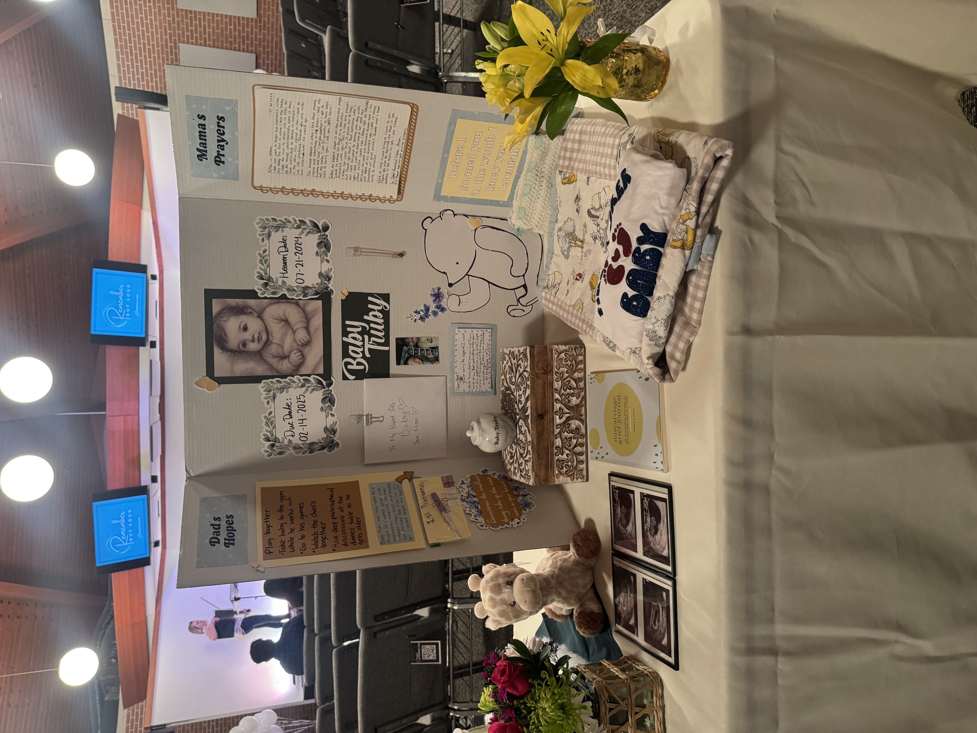 Memorial display with baby clothes and keepsakes