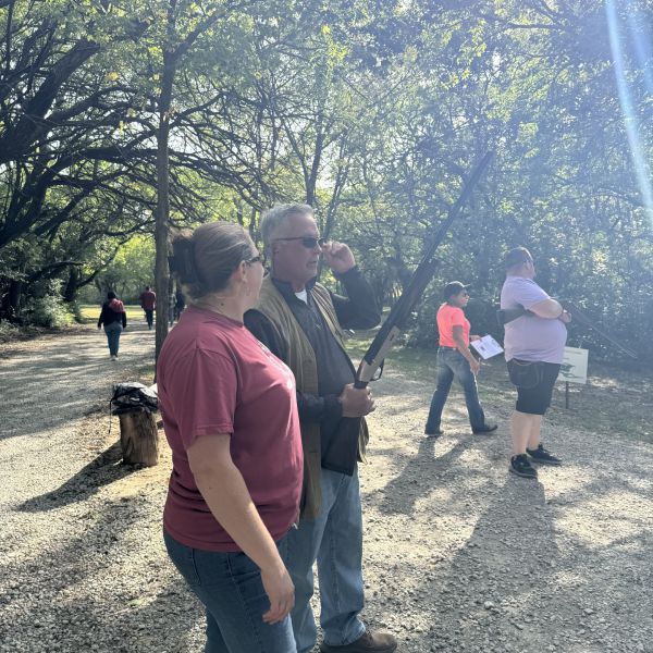 People_standing_under_trees_talking