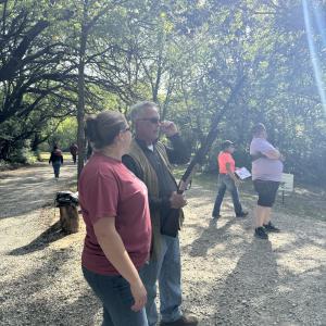 People_standing_under_trees_talking