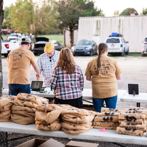 Crowd_gathered_around_tables_with_supplies