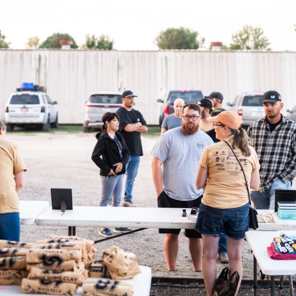 Gathering_of_people_around_a_table_with_goods