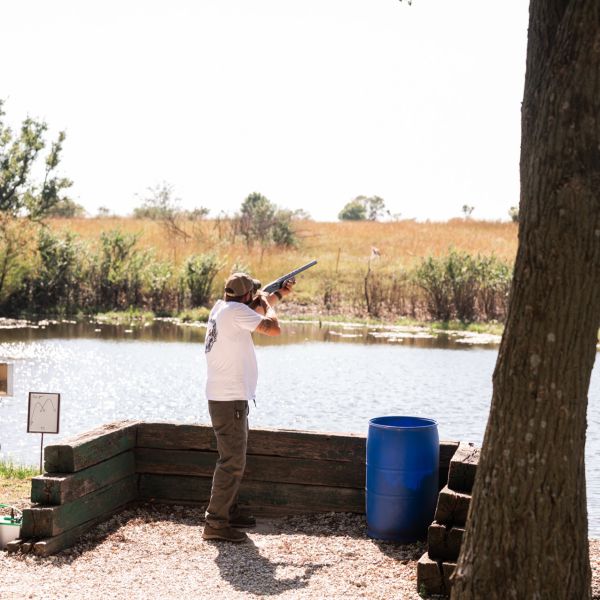Man_shooting_clay_at_fishing_pond