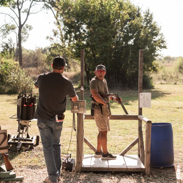 Men_preparing_clay_at_outdoor_shooting_range