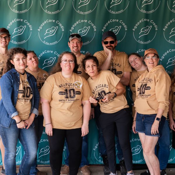 Team_posing_with_banner_and_tshirts