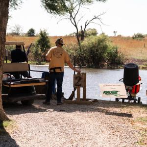 Man_getting_clay_ready_near_lake